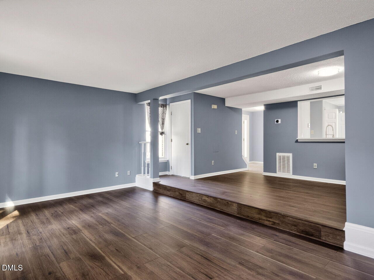 4333 Halliwell Drive Raleigh, NC 27606 - Photo 9 of 31 an empty room with wooden floor and windows