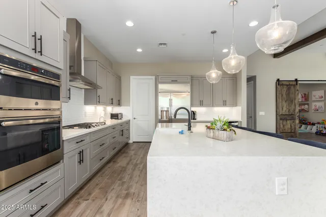 a large kitchen with a table and chairs