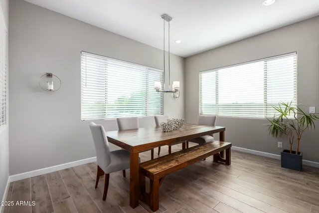 a large kitchen with stainless steel appliances a large counter top a stove and a refrigerator