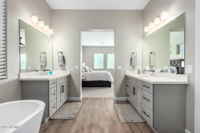 a spacious bedroom with a bed and a flat screen tv