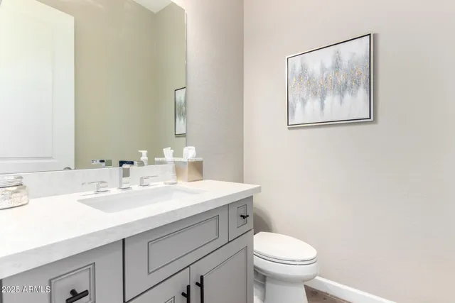 a bedroom with a bed lamp closet and three large window