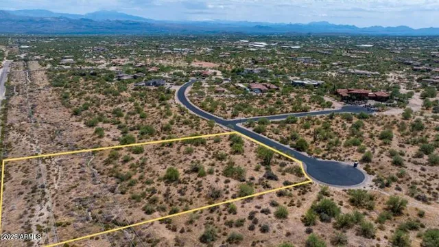 a view of a garden with lawn chairs