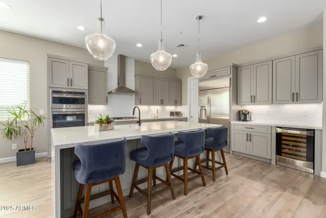 a living room with stainless steel appliances granite countertop furniture a fireplace and a large window