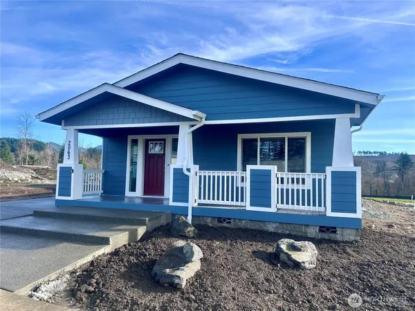 a front view of a house with garden and porch