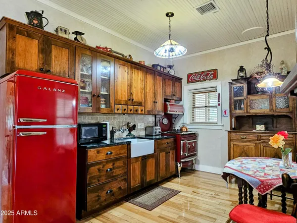 a kitchen with stainless steel appliances granite countertop a stove refrigerator and cabinets