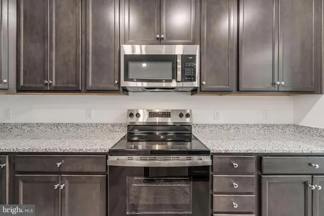 a view of kitchen with kitchen island a sink wooden floor and kitchen island