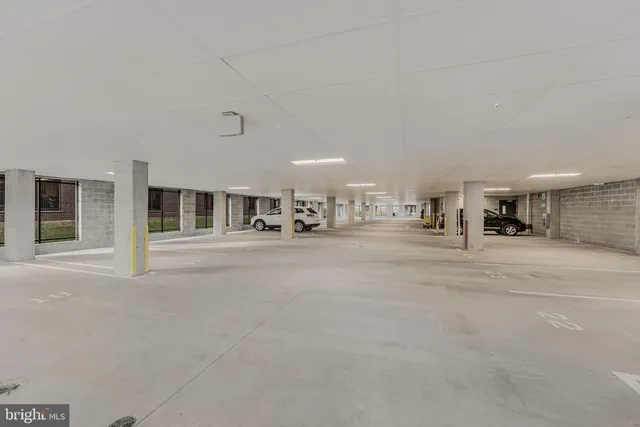 a large kitchen with stainless steel appliances granite countertop a stove a sink dishwasher a microwave oven and a oven with wooden cabinets