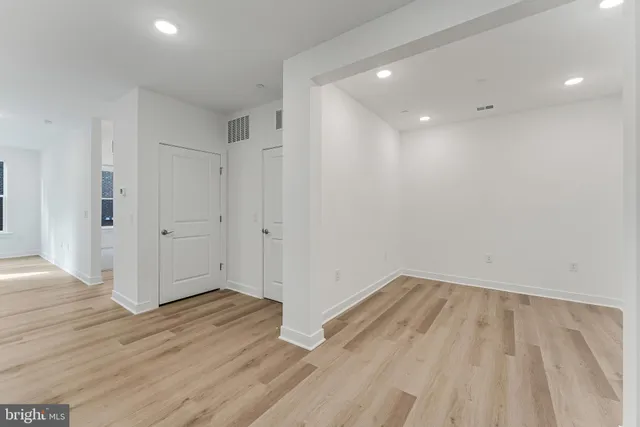 a large kitchen with kitchen island a sink stainless steel appliances and cabinets