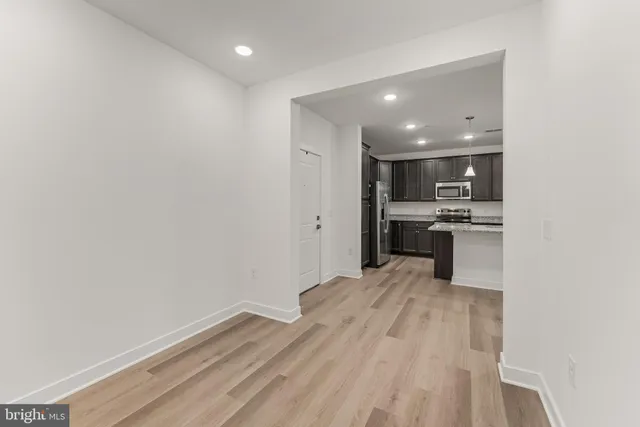 a kitchen with kitchen island a sink stainless steel appliances and cabinets