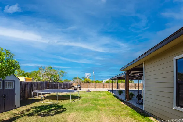 a view of a backyard with plants and patio