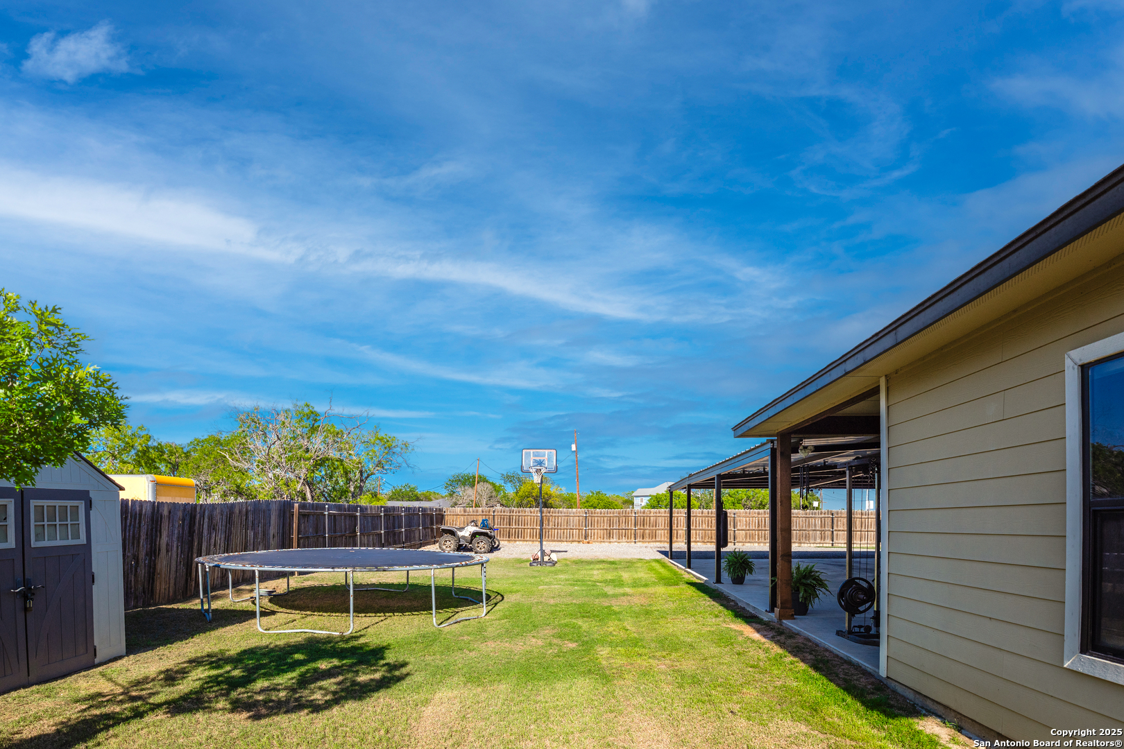1038 Avenue H Poteet, TX 78065 - Photo 12 of 16 a view of a backyard with plants and patio