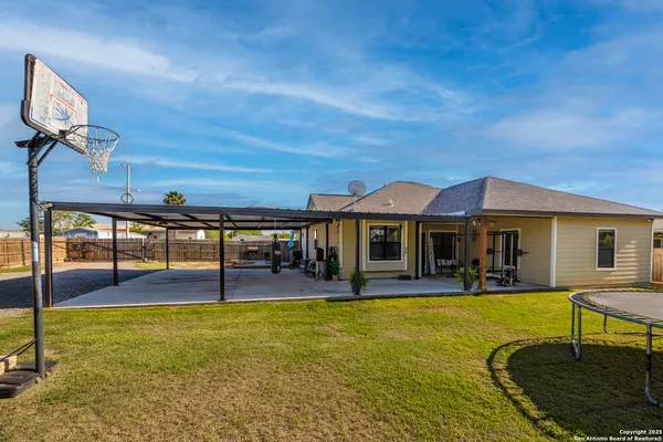 a view of a house with swimming pool yard and patio