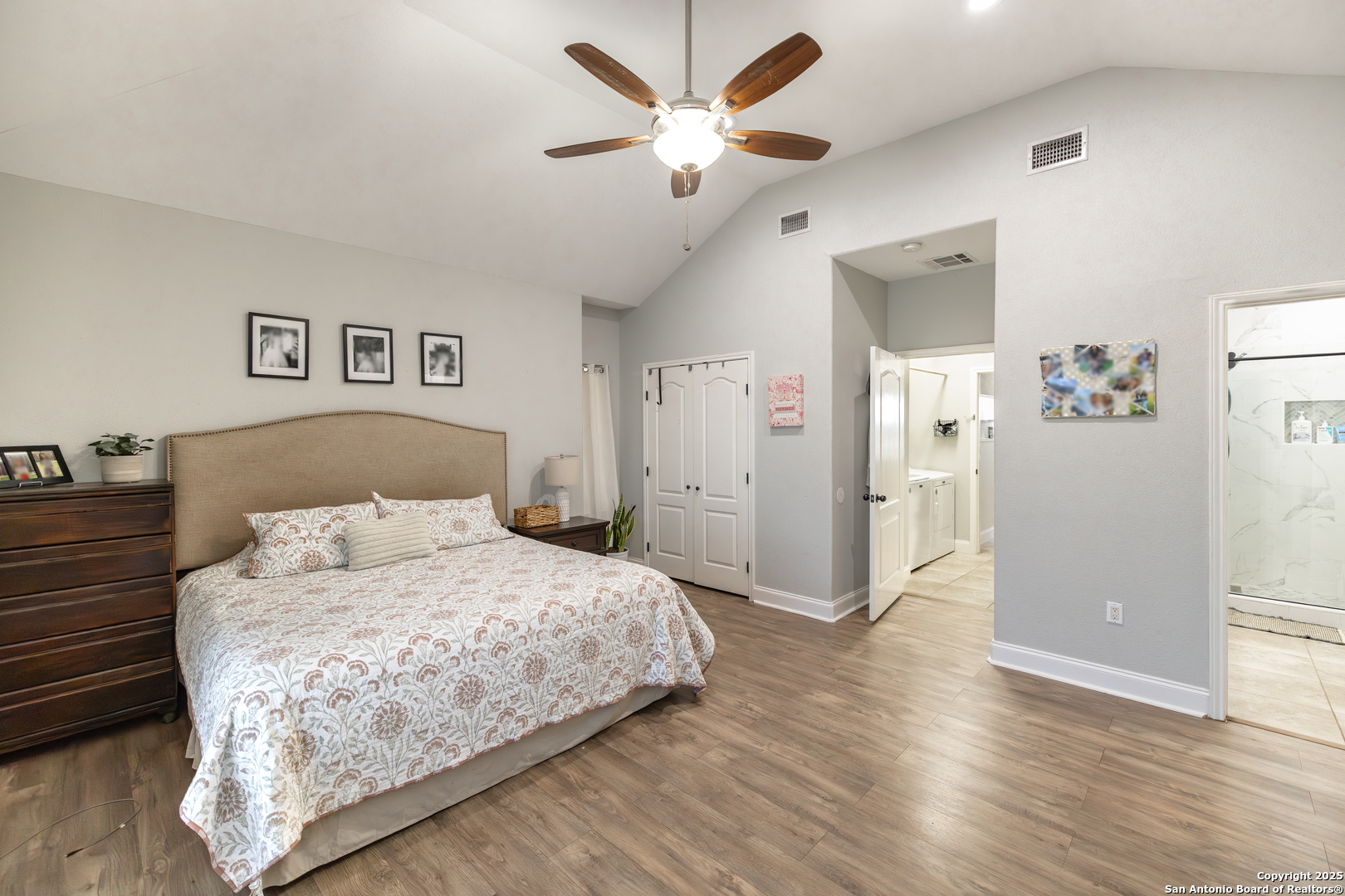 1038 Avenue H Poteet, TX 78065 - Photo 7 of 16 a bedroom with a large bed and a ceiling fan