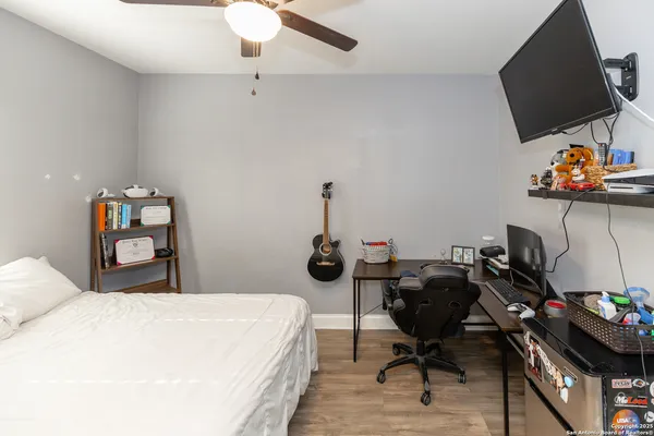 a bedroom with a bed and a flat screen tv