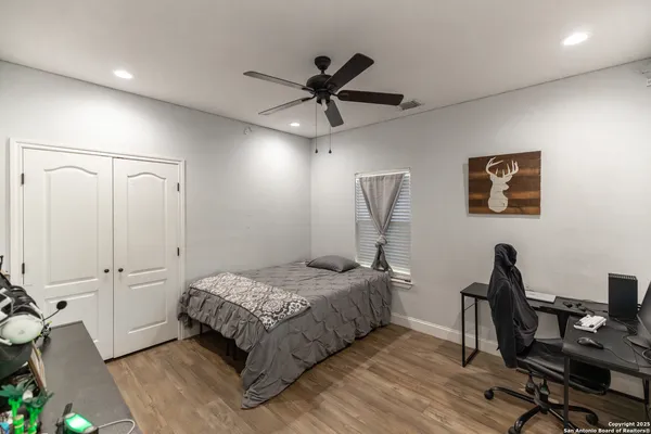 a bedroom with a bed and a desk