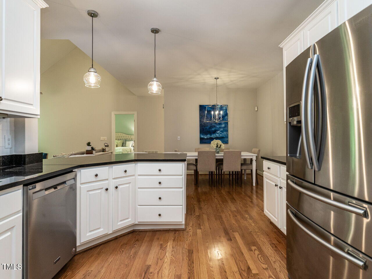 12205 Glenlivet Way Raleigh, NC 27613 - Photo 14 of 37 a kitchen with stainless steel appliances a refrigerator sink and wooden floor