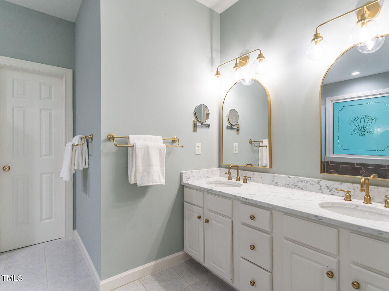 12205 Glenlivet Way Raleigh, NC 27613 - Photo 19 of 37 a bathroom with a double vanity sink and a mirror