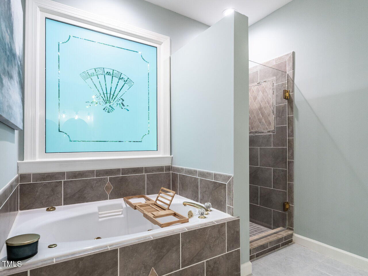 12205 Glenlivet Way Raleigh, NC 27613 - Photo 20 of 37 a bathroom with a bathtub and a sink