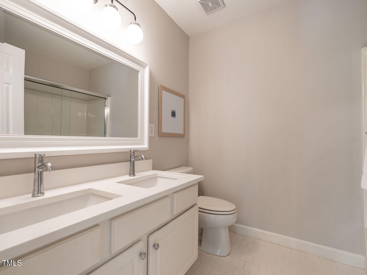 12205 Glenlivet Way Raleigh, NC 27613 - Photo 24 of 37 a bathroom with a toilet sink and mirror