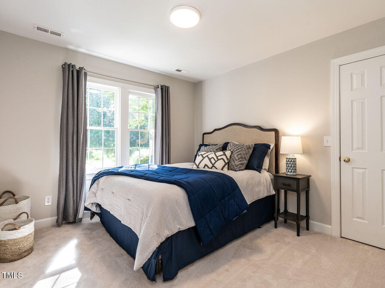 12205 Glenlivet Way Raleigh, NC 27613 - Photo 25 of 37 a bedroom with a bed and window