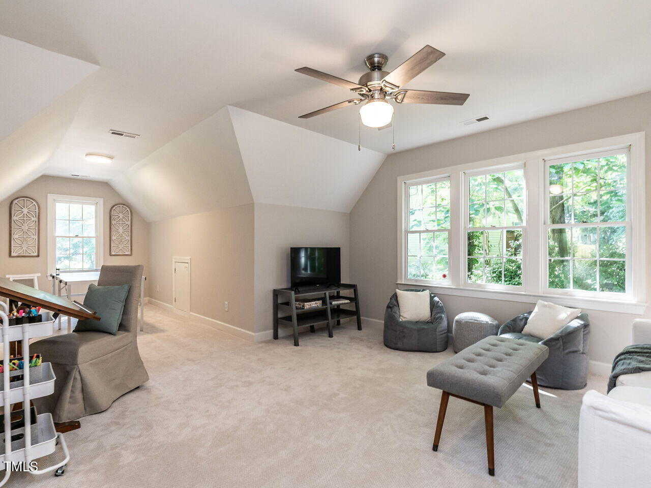 12205 Glenlivet Way Raleigh, NC 27613 - Photo 26 of 37 a living room with furniture and a flat screen tv