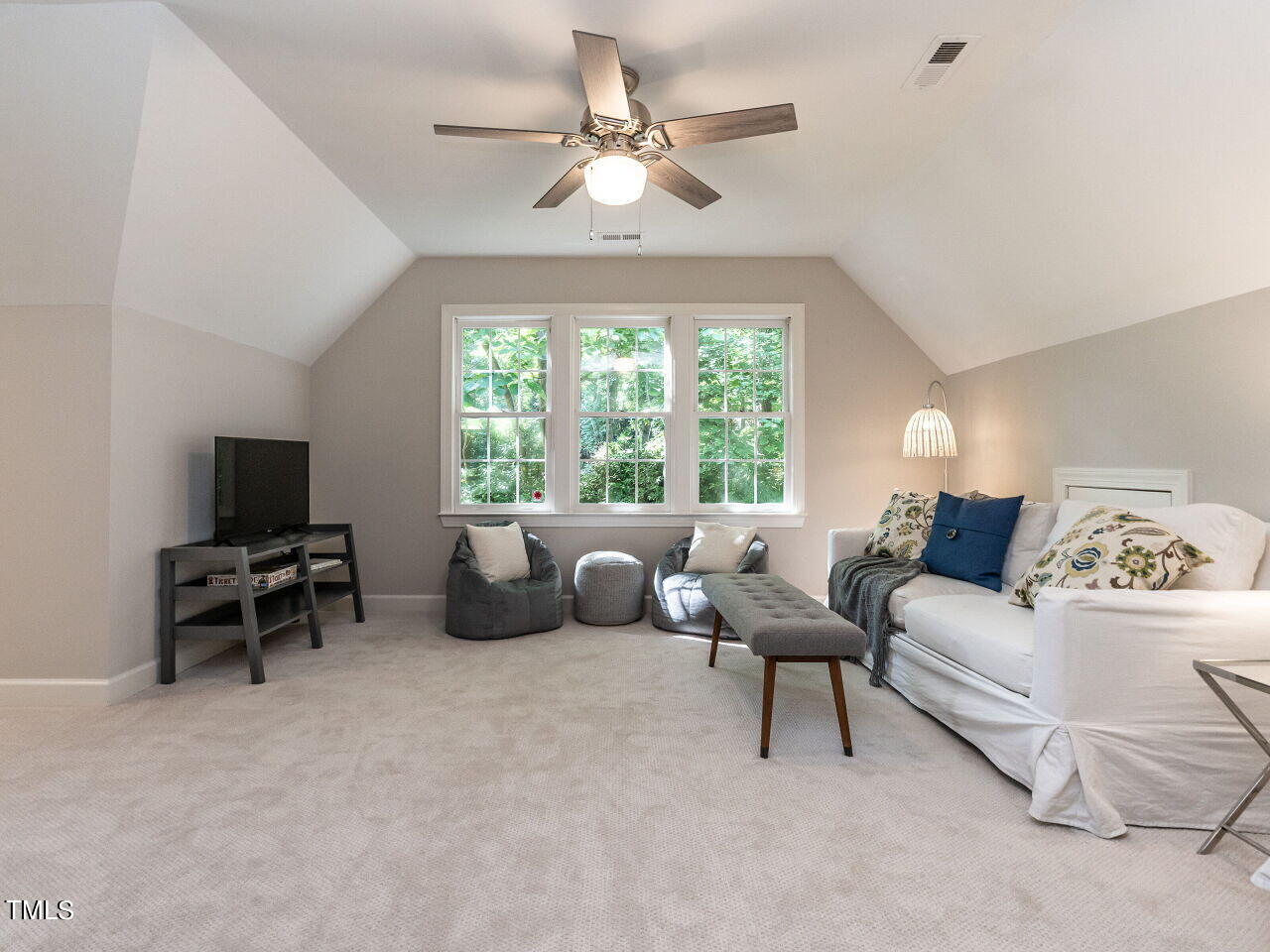 12205 Glenlivet Way Raleigh, NC 27613 - Photo 27 of 37 a living room with furniture and a flat screen tv