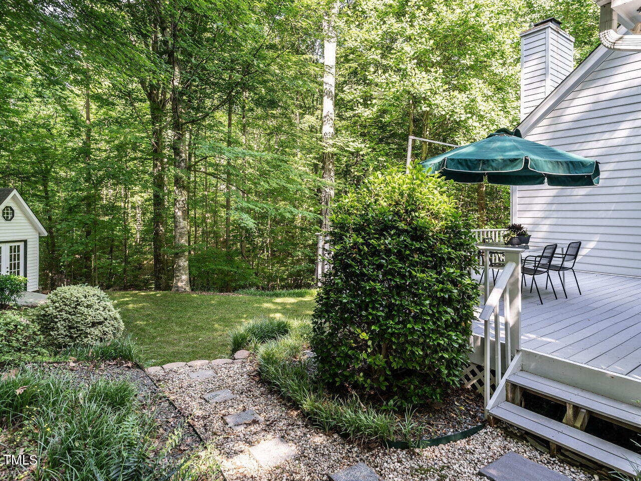 12205 Glenlivet Way Raleigh, NC 27613 - Photo 29 of 37 a view of backyard with seating space and trees