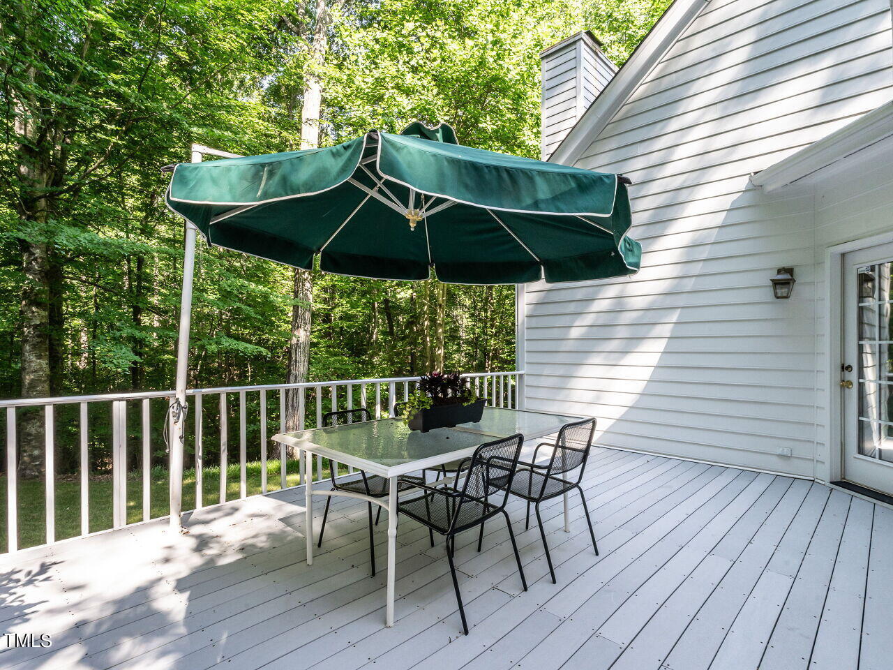 12205 Glenlivet Way Raleigh, NC 27613 - Photo 31 of 37 a deck with wooden floor and umbrella
