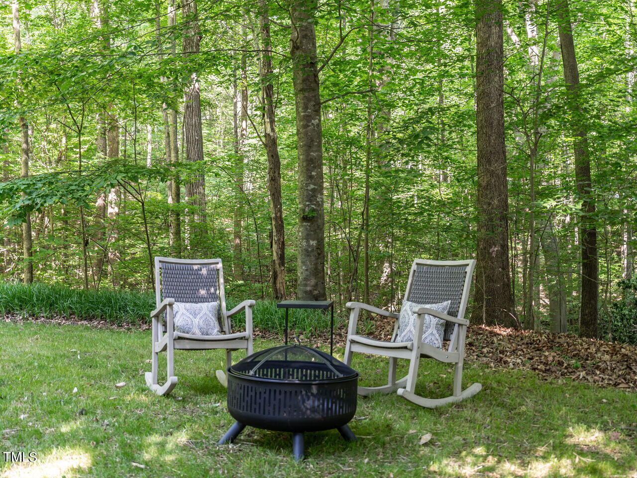 12205 Glenlivet Way Raleigh, NC 27613 - Photo 35 of 37 a view of a chair and fire pit in the backyard