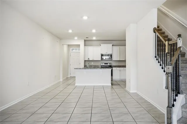 a view of kitchen with stainless steel appliances a refrigerator and cabinets