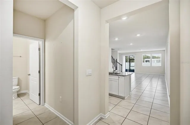 a view of a kitchen with refrigerator and sink
