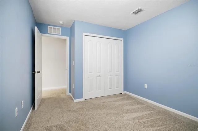 an empty room with large windows