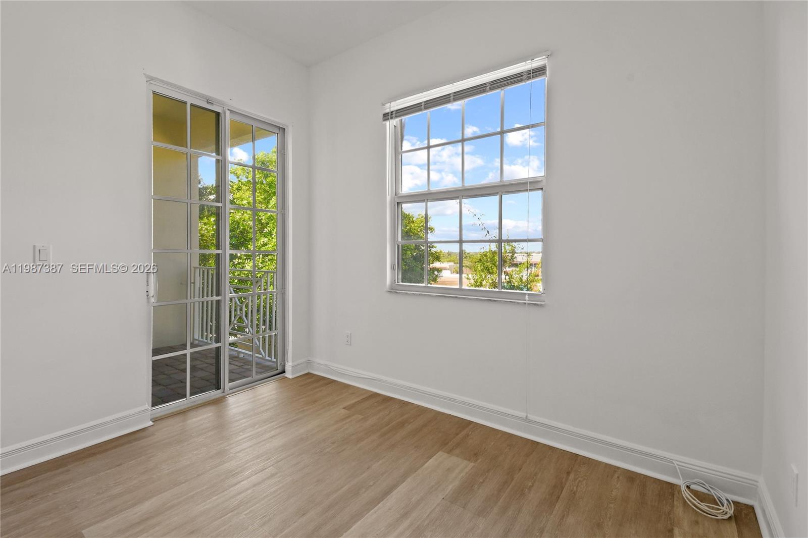 475 Ocean Ridge Way Juno Beach, FL 33408 - Photo 29 of 56 an empty room with wooden floor and windows