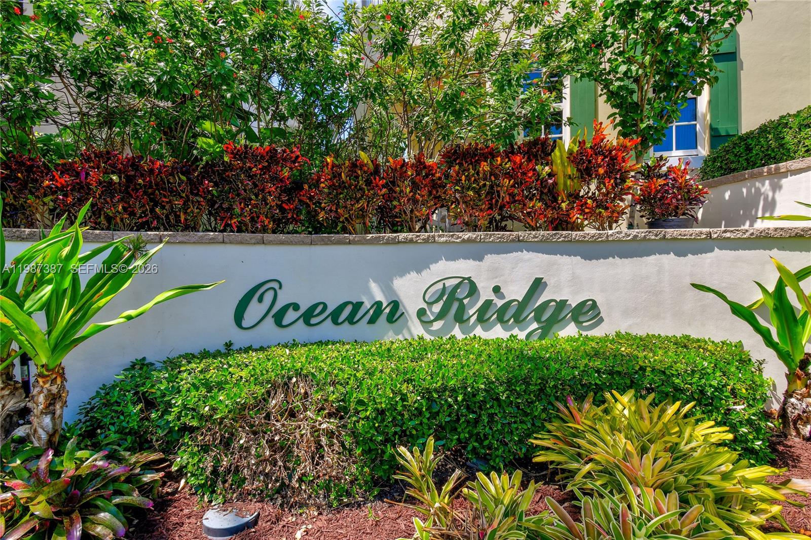 475 Ocean Ridge Way Juno Beach, FL 33408 - Photo 33 of 56 a street sign that is sitting in front of flowers