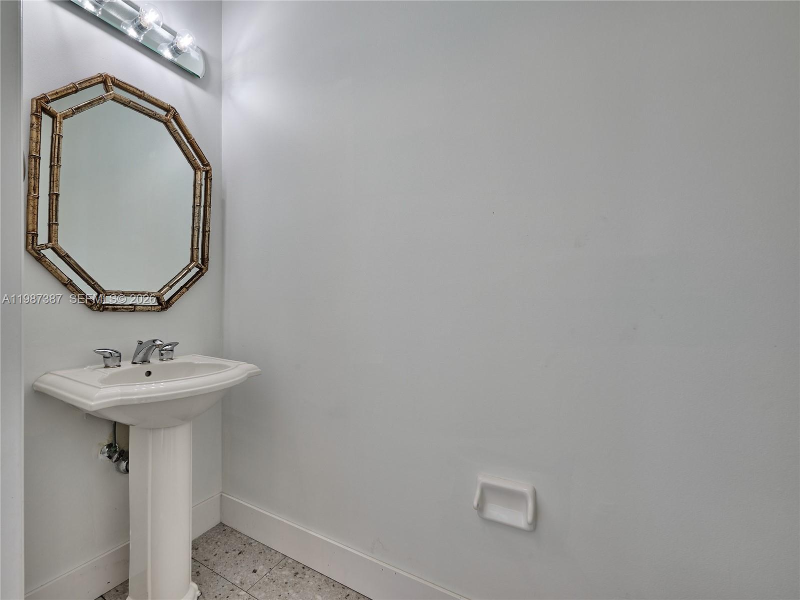475 Ocean Ridge Way Juno Beach, FL 33408 - Photo 41 of 56 a bathroom with a sink and mirror