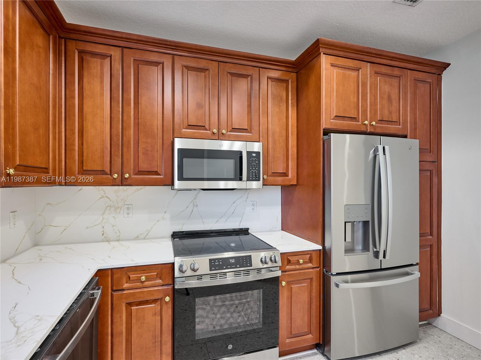 475 Ocean Ridge Way Juno Beach, FL 33408 - Photo 54 of 56 a kitchen with stainless steel appliances granite countertop a refrigerator and a stove top oven