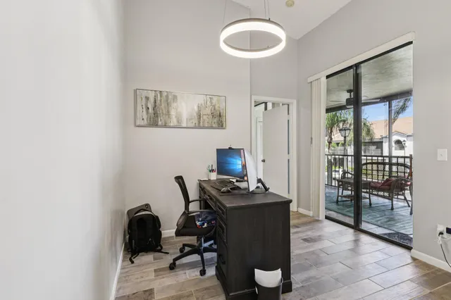 a bedroom with a bed and a lamp on dresser
