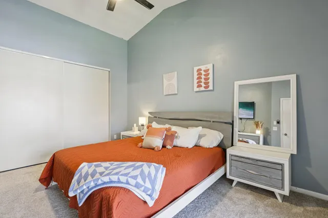 a bedroom with bed and balcony