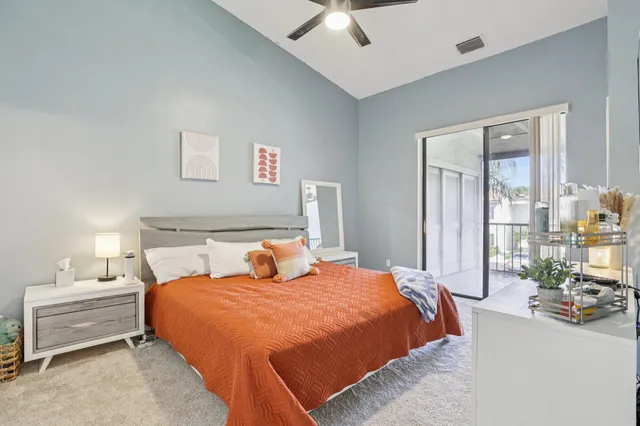 a bedroom with a large bed and a flat screen tv