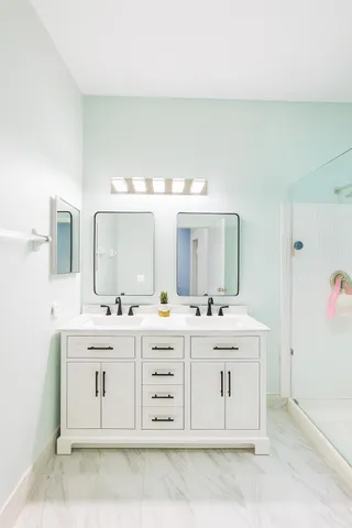 a bathroom with a sink a toilet and shower