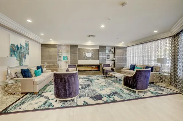 a living room with furniture a flat screen tv and a rug