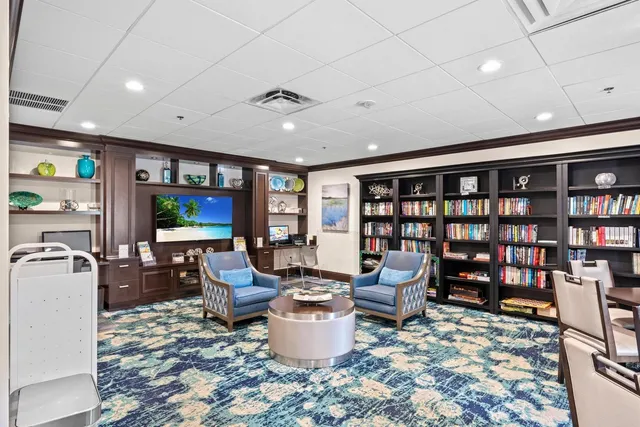 a view of a bedroom with wooden floor and window