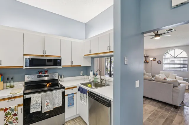 a kitchen with a refrigerator sink and cabinets