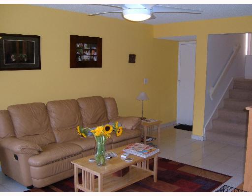 1149 Northwest 13th Street, Unit 8 Boca Raton, FL 33486 - Photo 3 of 10 a living room with furniture and wooden floor