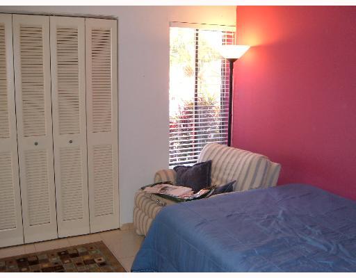 1149 Northwest 13th Street, Unit 8 Boca Raton, FL 33486 - Photo 6 of 10 a bedroom with a bed and a window