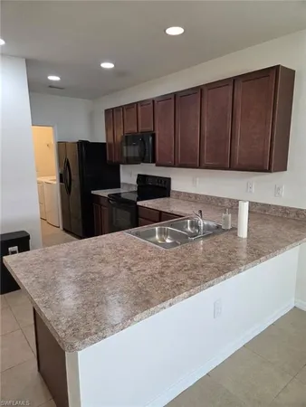a kitchen with refrigerator and cabinets