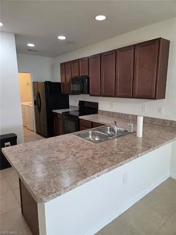 a kitchen with refrigerator and cabinets