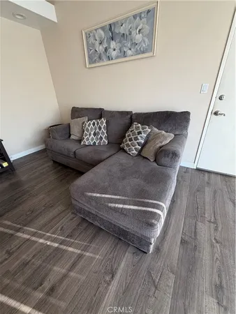 a living room with couch and wooden floor