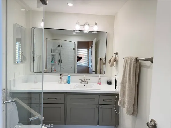 a bathroom with a sink vanity and a mirror