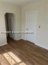 an empty room with wooden floor